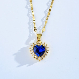 Elegant gold heart pendant necklace featuring a blue sapphire center and crystal halo