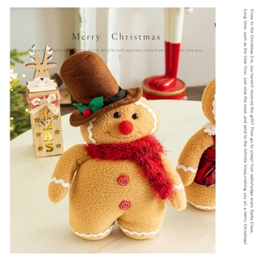 Detail of gingerbread man plush doll with red scarf and hat on a festive desk