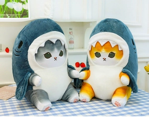 Detailed close-up of gray and orange shark cat plush toys on a checkered tablecloth