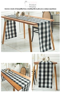 Detail of black and white checkered table runner with woven cotton linen texture