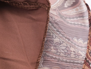 Detail of bohemian dress showing paisley fabric stitching with clean overlock seams
