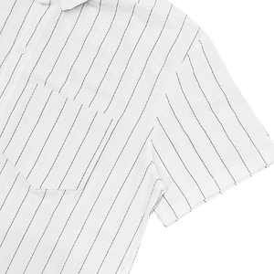 Detail of white striped shirt showing linen texture, chest pocket and vertical black lines