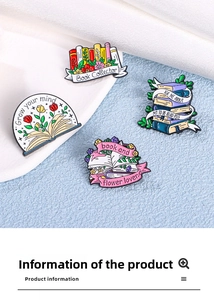 Close-up of four enamel book pins with flower designs for backpacks and clothes