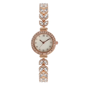 Detail of rose gold watch featuring mother-of-pearl dial and crystal-encrusted leaf links