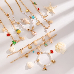 Bohemian gold layered necklace and bracelet set with ocean shells and starfish charms