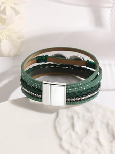 Close-up of green bohemian leather wrap bracelet with crystal inlay and magnetic buckle