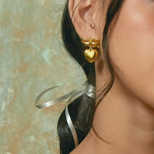 Golden butterfly and heart earrings for women made of durable stainless steel on model