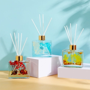 100ml square glass diffuser bottles with preserved flowers and white reeds on white stand