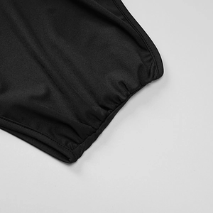 Detail of black knitted dress showing elastic cuff and reinforced stitching texture