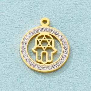 Golden Hamsa Hand and Star of David pendant with sparkling zircon accents on outer ring