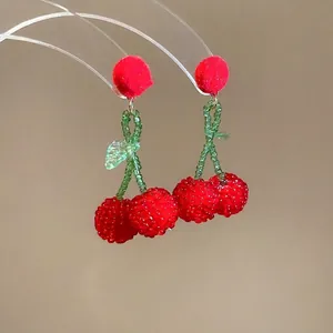 Sweet handmade beaded cherry drop earrings with red pompom and green leaf detail