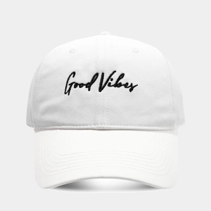 Detailed view of Good Vibes embroidery on a white cotton canvas baseball cap