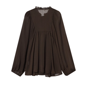Detail of ruffle stand collar and sheer chiffon texture on a coffee-colored blouse