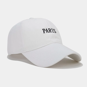 Detail of high-quality white cotton baseball cap with black PARIS embroidery and stitching