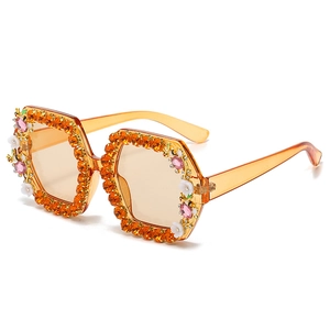 Oversized amber square sunglasses with orange rhinestones and white floral accents