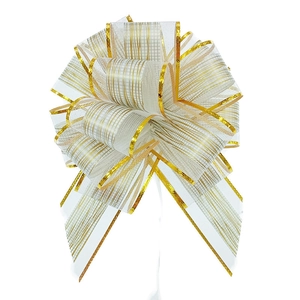 Detail shot of a white and gold striped ribbon bow for Christmas gift wrapping