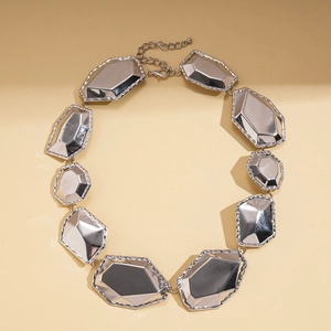 Detailed view of silver geometric faceted metal necklace with irregular polygon link design