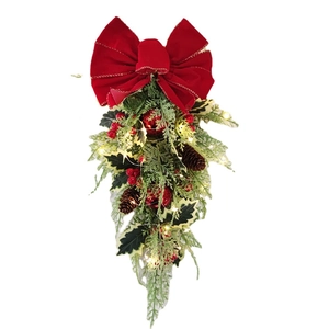 Christmas upside down tree decoration with red bow pine cones and LED lights on white background