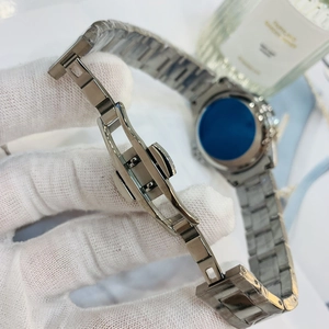 Close-up of silver stainless steel watch strap with butterfly clasp and protective film