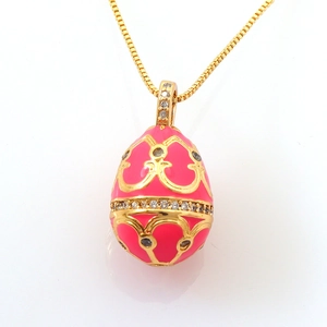 Faberge-style pink enamel egg pendant necklace with golden vine patterns and zircons