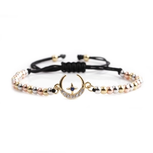 Three-tone beaded moon and star charm bracelet with sparkling cubic zirconia on white background
