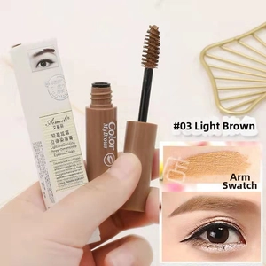 Detail view of light brown eyebrow gel with spiral brush applicator and arm swatches