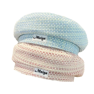 Chic tweed beret hats in pink and blue blend featuring a vintage Mniya logo patch