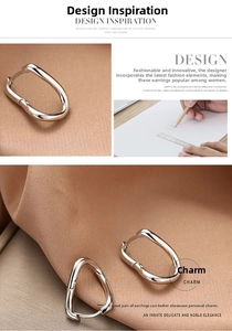 Détails des boucles d'oreilles argentées torsadées en U sur fond de tissu en soie élégant