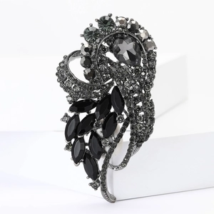 Macro detail of high-end alloy brooch with faceted black marquise glass and rhinestones