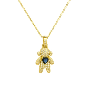 Macro detail of gold plated bear pendant with pavé cubic zirconia and blue heart stone