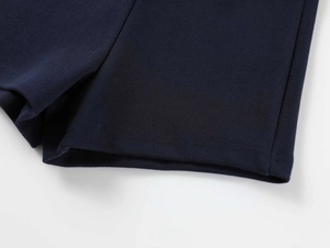 Macro detail of high-density navy blue yoga shorts featuring durable double-needle stitching