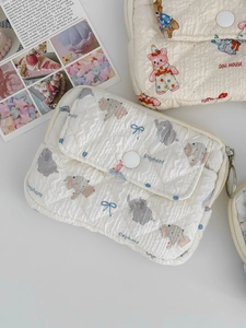 Detailed close-up of quilted coin purse featuring cute elephant and doll house prints