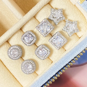 Detailed view of silver stud earrings set featuring star, square, and round crystal shapes