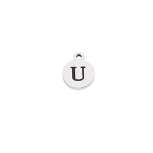 Macro detail of silver stainless steel round pendant with engraved black letter U