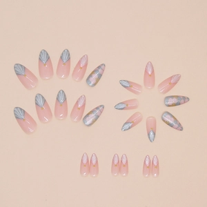 Short almond press-on nails with nude pink base, shell 3D textures, and gold bead accents