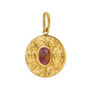 Macro detail of vintage round gold pendant with purple gemstone and hammered texture