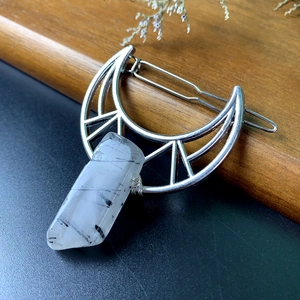 Detail of silver moon hair clip with a hanging black rutilated quartz crystal gemstone