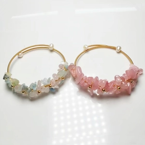 Detail of 14K gold wire wrapped bracelets with natural crystal stones and freshwater pearls