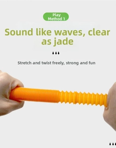 Hands stretching a flexible orange corrugated pop tube toy for sensory stress relief