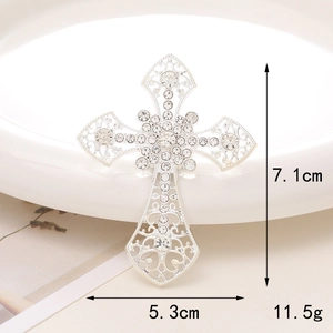 Silver hollow cross accessory with sparkling white rhinestones and floral center design