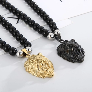 Macro view of lion head pendants in gold and black with 8mm black onyx beads necklaces