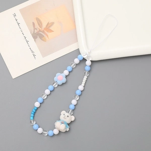 Handmade beaded phone charm with a blue bear and floral design on white beads
