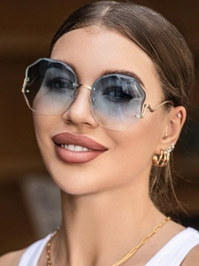 Close-up of rimless sunglasses with blue gradient lenses and wavy cut edges