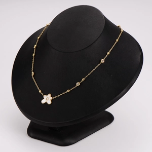 Elegant gold stainless steel necklace with white diamond-set flower pendant on neck model