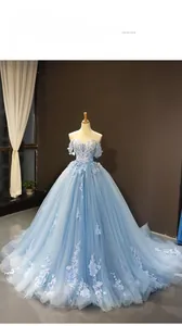 Detail of sky blue off-shoulder bridal gown with 3D floral lace embroidery and train
