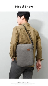 Men's grey Oxford fabric messenger bag shown from a back view worn by a male model