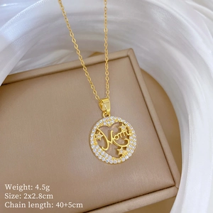 Macro shot of gold Mom pendant with stars and crystals including size and weight specs
