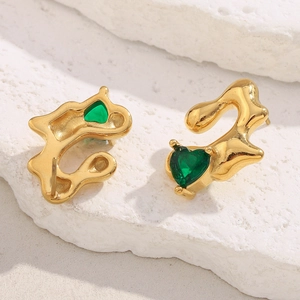 Macro shot of 18K gold plated irregular earrings with green heart-shaped gemstones