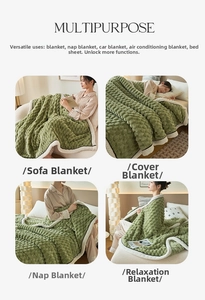 Detail of sage green multi-purpose blanket with embossed dot texture and soft fleece trim