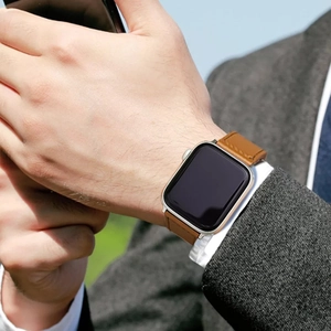 Brown leather magnetic link strap for smart watch shown on a man wearing a suit